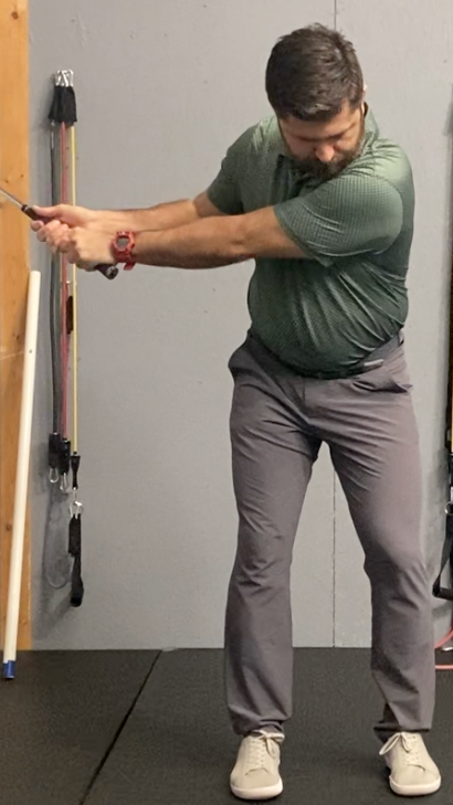 a golfer in mid swing demonstrating a casting characteristic that can and will lead to golfing with golfer's elbow.